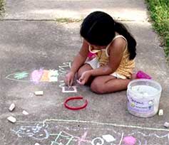 girl making chalk drawing